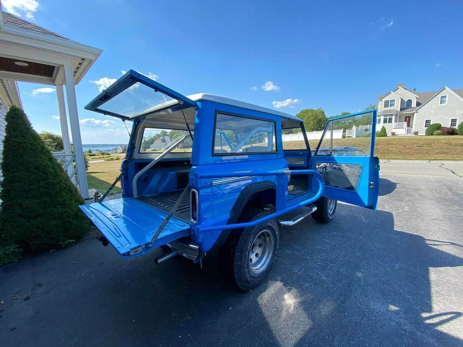 An old Ford Bronco sitting in a driveway. (Blue 1967 Ford Bronco)