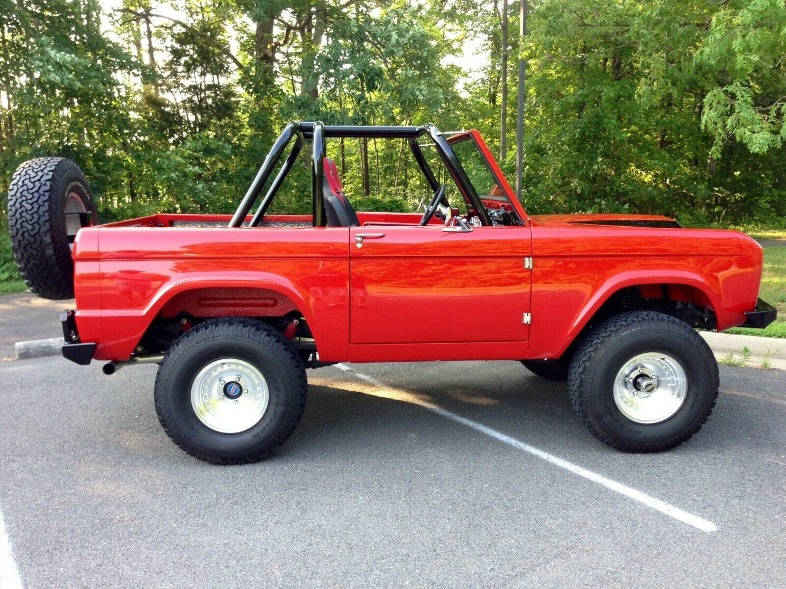 Red 1967 Bronco Restomod sitting in a parking lot