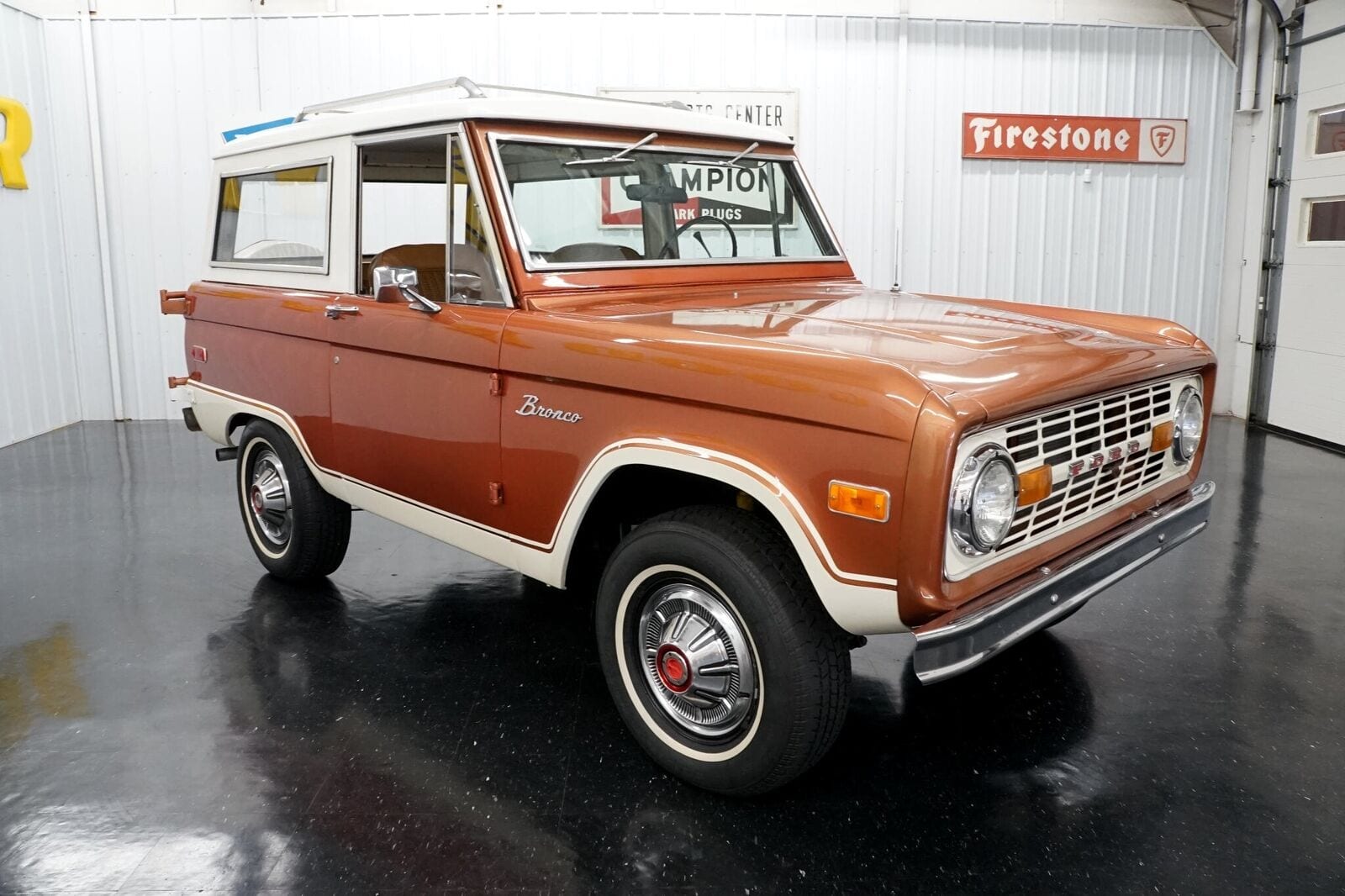 Hot Ginger 1974 Ford Bronco sitting in a garage