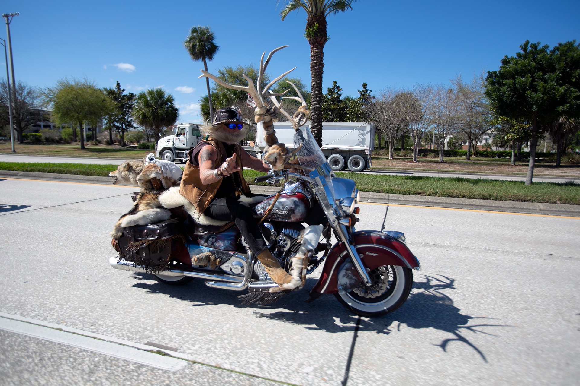 A uniquely decorated Indian motorcycle cruising by the Daytona International Speedway