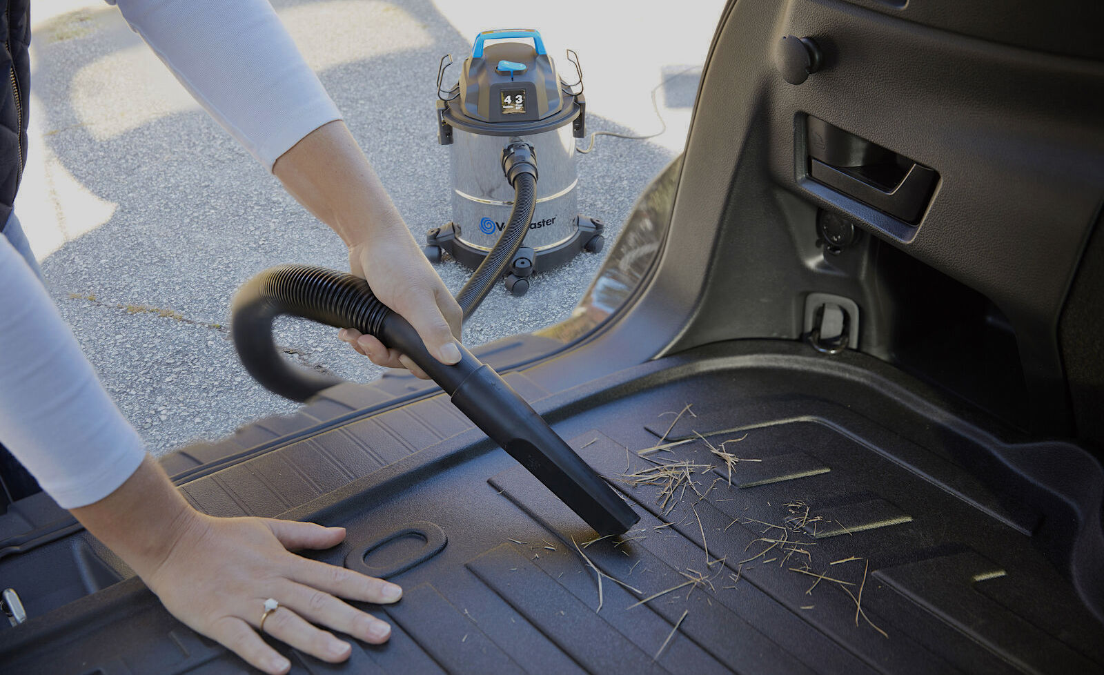 Cleaning the cargo area with a shop vacuum 