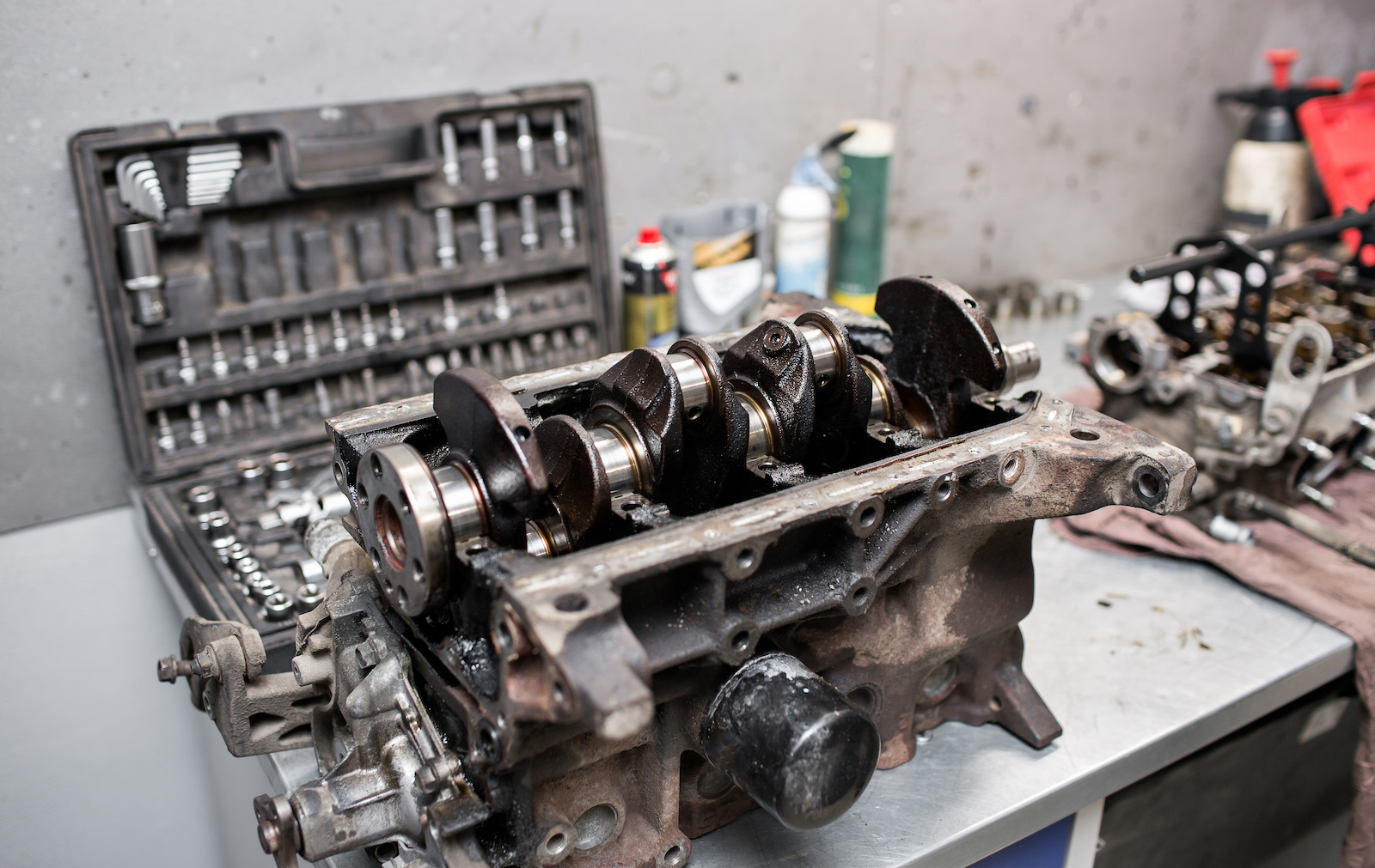 An engine block on the workbench, with the crankshaft exposed.