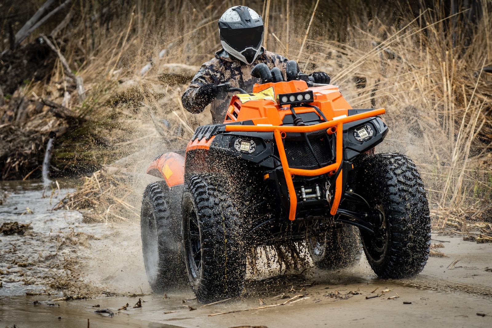 ATV driving through muddy water